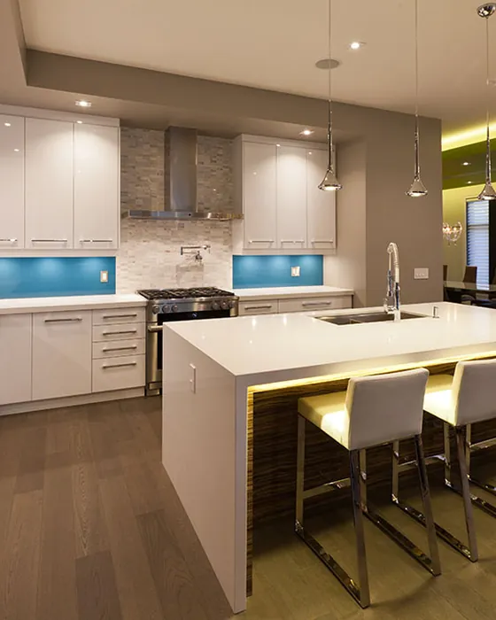 Remodeled modern kitchen with a large island, custom cabinetry and pendant lighting