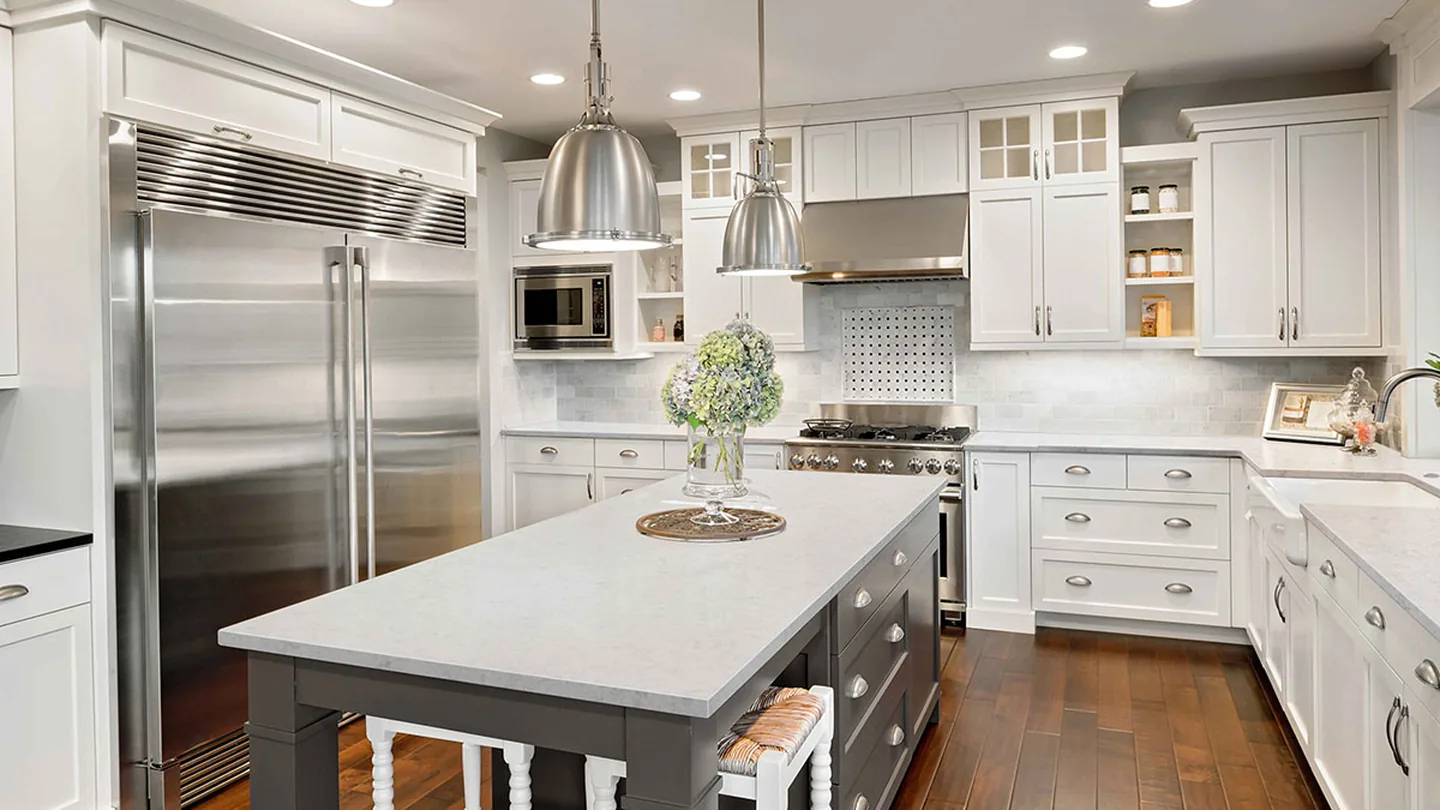 Finished luxury kitchen with a large island and custom cabinetry by Dwell Finish